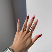 Vibrant hand adorned with Candy Red press-on nails, making a bold statement wherever you go.