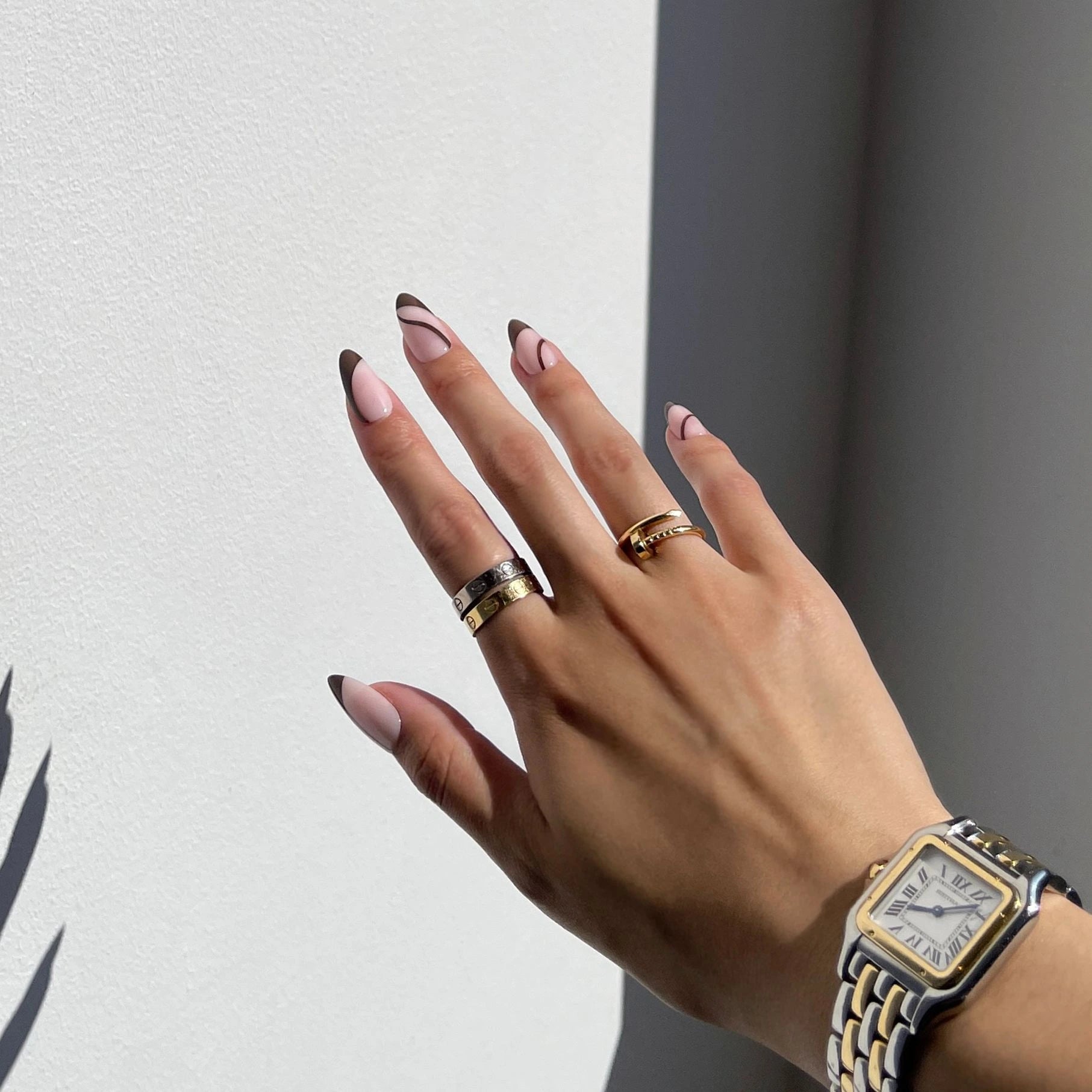 Chic hand wearing Dolce Vita press-on nails, a modern and trendy design for a stylish look.